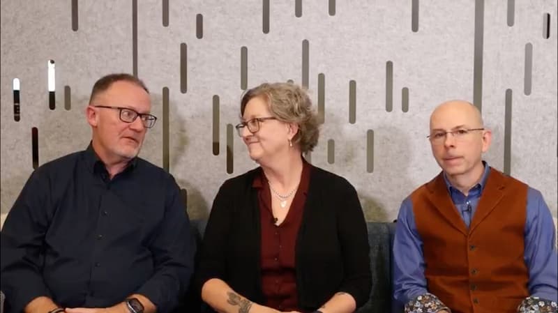 Three people sitting in chairs